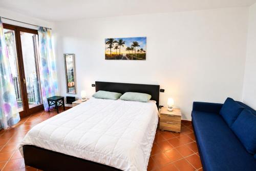 a bedroom with a bed and a blue couch at Shila House in Luino