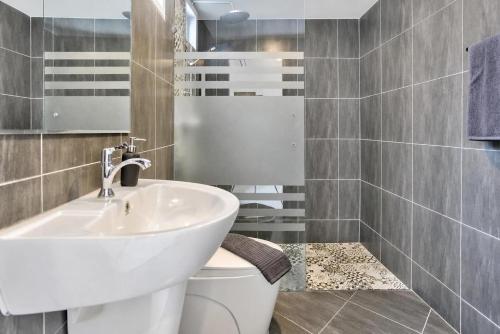 a bathroom with a white sink and a toilet at Luxury Pool Villa Pattaya Center C3- 3 Bedroom in Pattaya South