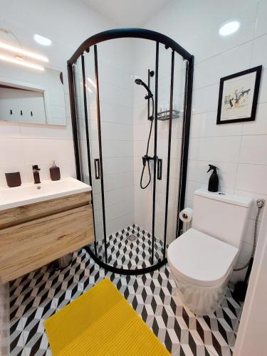 a bathroom with a shower with a toilet and a sink at BBB Parkside Studio city center in Budapest