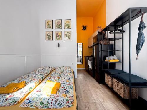 a bedroom with a bed and a black shelf at BBB Parkside Studio city center in Budapest