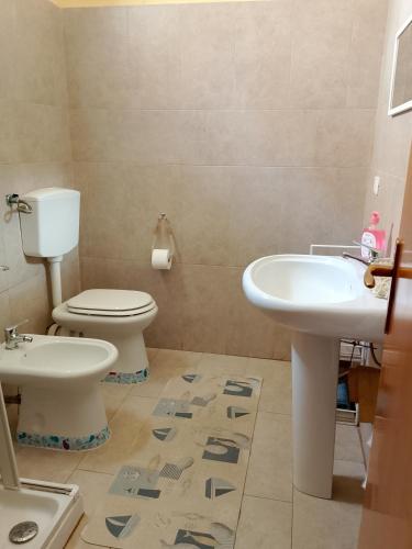 a bathroom with a toilet and a sink at Na' zà Ciccina in Palermo