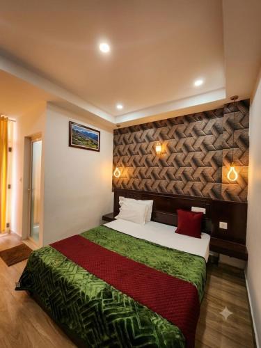 a bedroom with a large bed in a room at Parudeesa Pool Resort in Vattavada