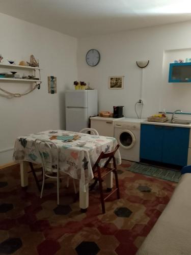 a kitchen with a table and a white refrigerator at Na' zà Ciccina in Palermo