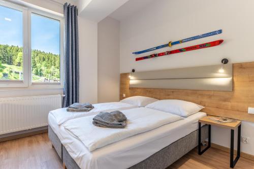 a bedroom with a bed and a window at Apartamenty Zieleniec in Duszniki Zdrój