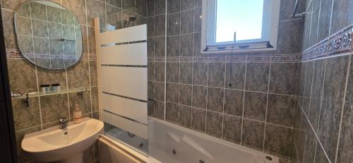 a bathroom with a sink and a mirror at Carisa Lighthouse by Staycom in Perivolia