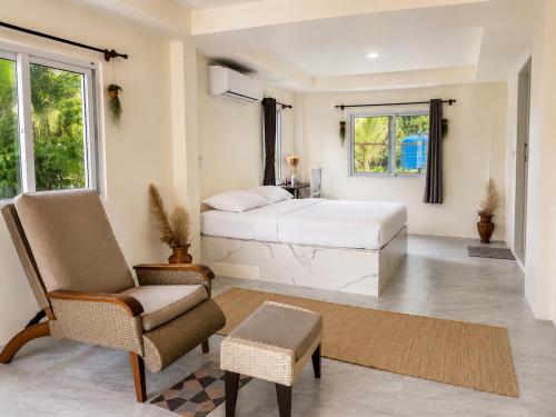 a bedroom with a bed and a chair at Kopan House View Point by WildFlower in Thong Sala