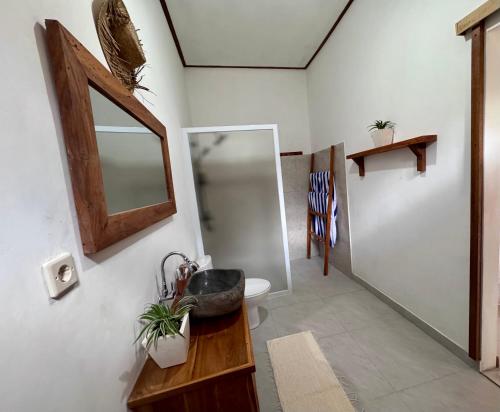 a bathroom with a sink and a mirror at AVYANA sanctuary in Gobleg