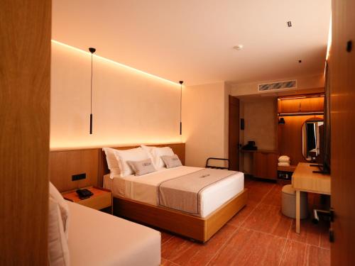 Ліжко або ліжка в номері Greg Hotel