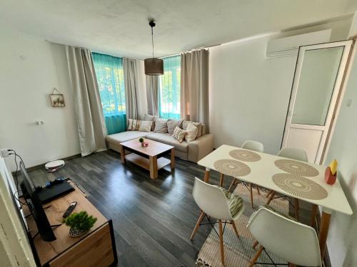 a living room with a table and a couch at Апартамент ''Габрува'' in Gabrovo