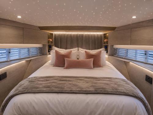 a large bed in a room with windows at The North Bank in Poole