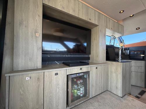 a living room with a tv and a fireplace at The North Bank in Poole