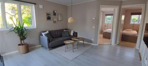 a living room with a couch and a table at Apartment Sollid - Your comfortable accommodation in Huskvarna