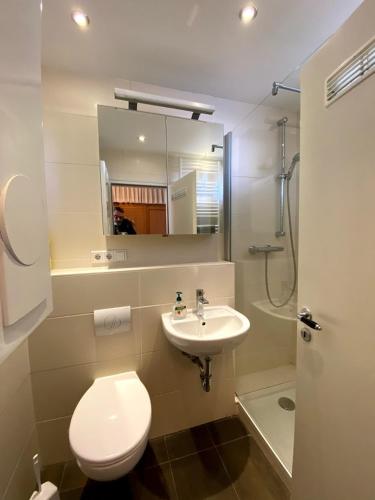 a bathroom with a toilet and a sink and a shower at Haus Nautic Whg 809 Seesicht in Cuxhaven