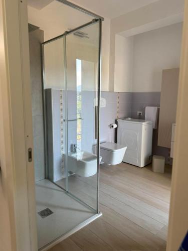 a bathroom with a glass shower and a sink at Domus Smeralda in Muravera