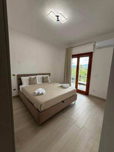 a bedroom with a large bed and a window at Domus Smeralda in Muravera