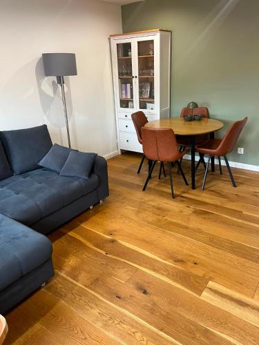 a living room with a couch and a table at Green House Giławy in Giławy