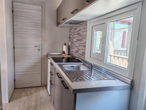a kitchen with a sink and a window at Camping Jonio in Catania