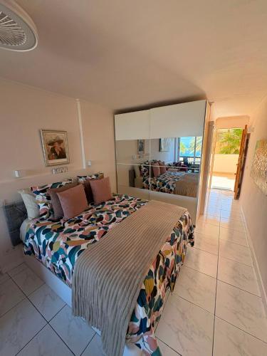 a bedroom with a large bed and a balcony at Nice Studio Apartment with Ocean View in Arguineguín