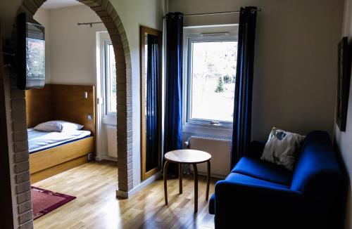a living room with a couch and a bed and a window at Hindåsgården Hotel & Spa in Hindås