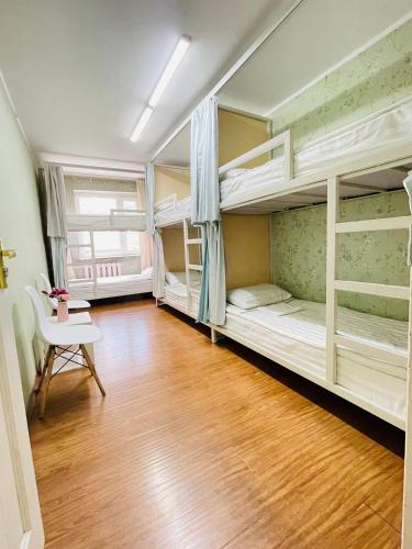 a room with two bunk beds and a table at Gobi - Zen in Ulaanbaatar