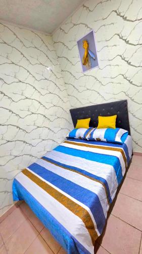 a bedroom with a bed with blue and white stripes at Apartamento MADERO in Buenos Aires