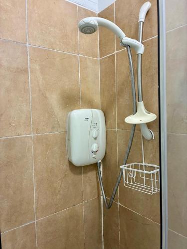 a shower head on the wall of a bathroom at Padoro Lodge in Kildare