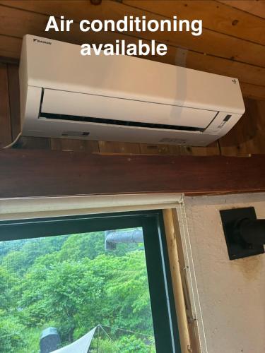 an air conditioning appliance hanging above a window at SHIZENTOYA Privete cottage for nature experience LakeView! in Lake Toya