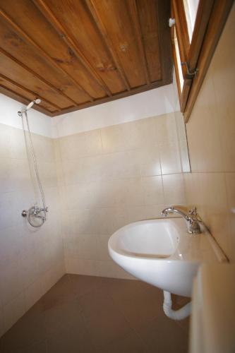 a bathroom with a sink and a shower at Kruchma Bratyata Guest House in Kovachevitsa