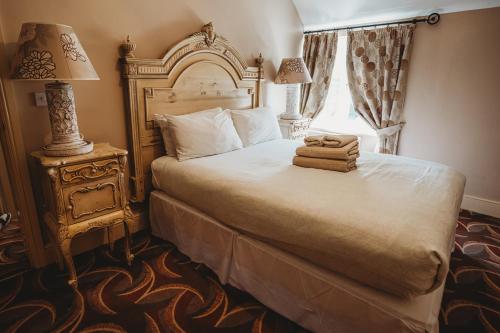 a bedroom with a bed with two towels on it at Mount Pleasant Hotel Self-Catering Cottages in Doncaster