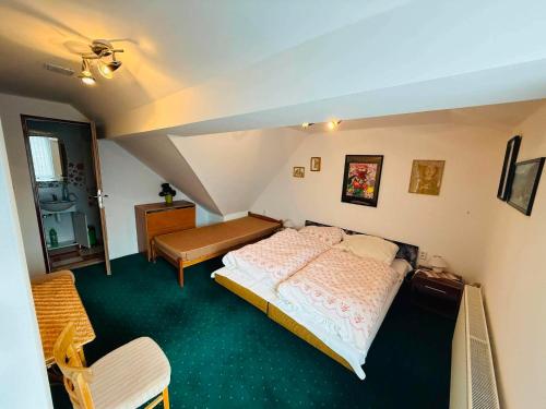 a bedroom with a large bed in a attic at Apart-Bungalovy Gitka in Mlynčeky