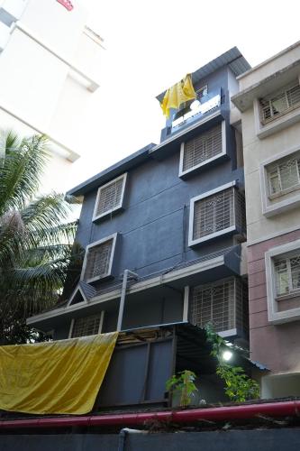 a blue building with a yellow flag on top of it at The Highstreet Legacy in Pune