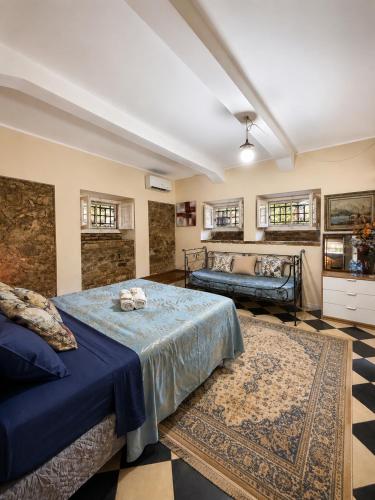 a large room with a bed and a couch at La Roccia in Reggio di Calabria