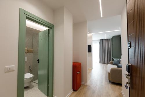 a bathroom with a red suitcase in a room at Oleva Sea View Suites in Sarandë