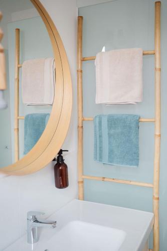 a bathroom with a mirror over a sink and towels at Schmidsdorf 67 in Payerbach