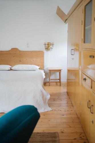 a bedroom with a white bed and a wooden floor at Schmidsdorf 67 in Payerbach