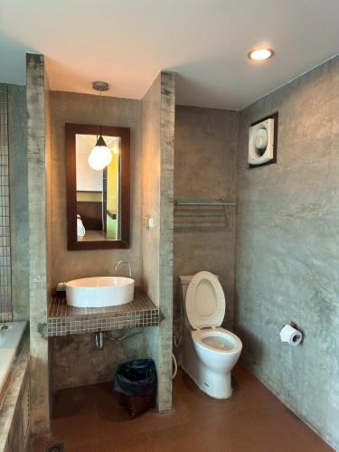 a bathroom with a sink and a toilet and a tub at Mandala House, Chiang Mai in Chiang Mai