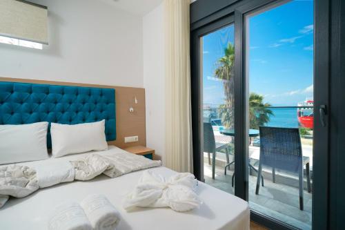 a bedroom with a bed and a view of the ocean at Hotel Medusa in Skala Prinou
