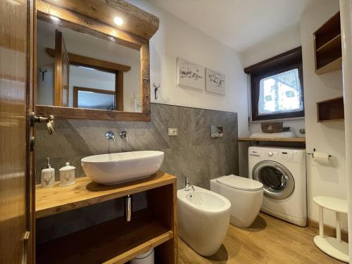 a bathroom with a sink and a washing machine at Central Spacious Apartment, Mountain Views in Sauze d'Oulx