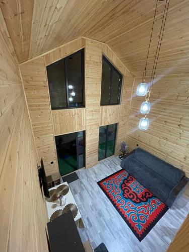 a room with a blue couch and a red rug at Банрхаус in Cholpon-Ata