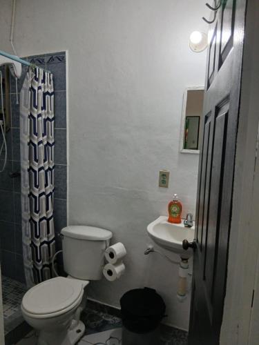 a bathroom with a toilet and a sink at Tuncosurfhouse in El Sunzal