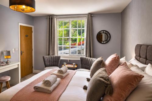 a bedroom with a large bed and a window at Bridgeside Rooms in Ironbridge