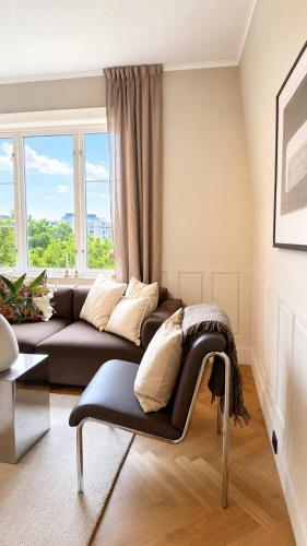 a living room with a couch in front of a window at SV3G 3BR Villa with Patio in Oslo