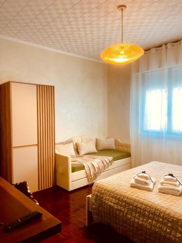 a bedroom with two beds and a yellow light at casa TRE19 in Mantova