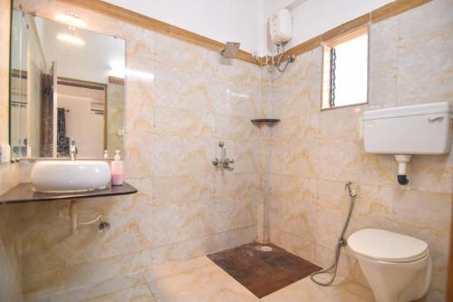 a bathroom with a toilet and a sink at ll EMPYREAN STAYS ll BLACK PANTHER VILLA ll in Lonavala