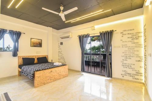 a bedroom with a bed and a window with writing on the wall at ll EMPYREAN STAYS ll BLACK PANTHER VILLA ll in Lonavala
