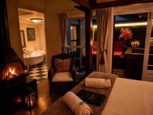 a living room with a bed and a bath tub at Goblin's Creek in St. Helena Bay
