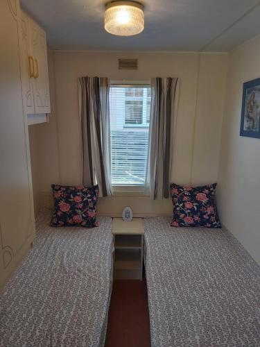 a small room with two beds and a window at Sky house in Jūrmala