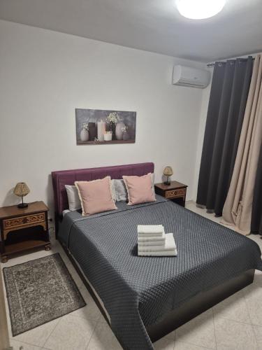 a bedroom with a bed and two night stands at Casa Maya Langhe e Roero in Pocapaglia