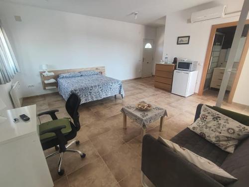a living room with a bed and a couch at La pineda in Les tres Cales