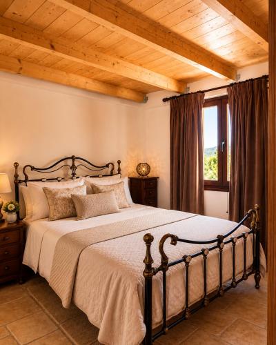 a bedroom with a large bed with a wooden ceiling at 5 Stars Villas in Svoronata